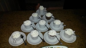 Pyramid of spiced chocolate pots de creme topped with whipped cream in espresso cups.